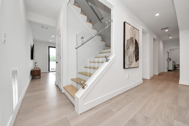 5327 S Braeswood Blvd, Houston, TX 77096 - staircase featuring wood finished floors, recessed lighting, and baseboards