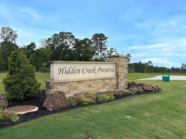 community / neighborhood sign with a lawn