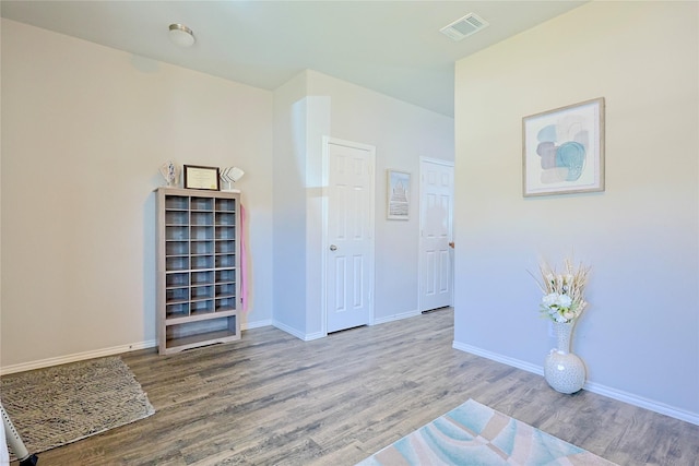 interior space featuring visible vents, baseboards, and wood finished floors