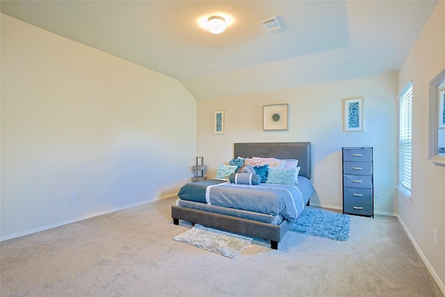bedroom with carpet, visible vents, multiple windows, and baseboards