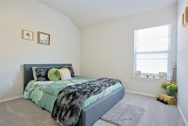 bedroom featuring baseboards, multiple windows, carpet, and lofted ceiling