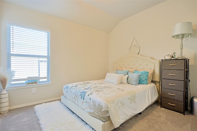 bedroom with light carpet, baseboards, and lofted ceiling