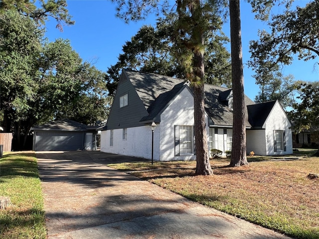 602 Rosewood Dr, Shenandoah, TX 77381 - view of property exterior featuring brick siding, concrete driveway, an attached garage, and a lawn