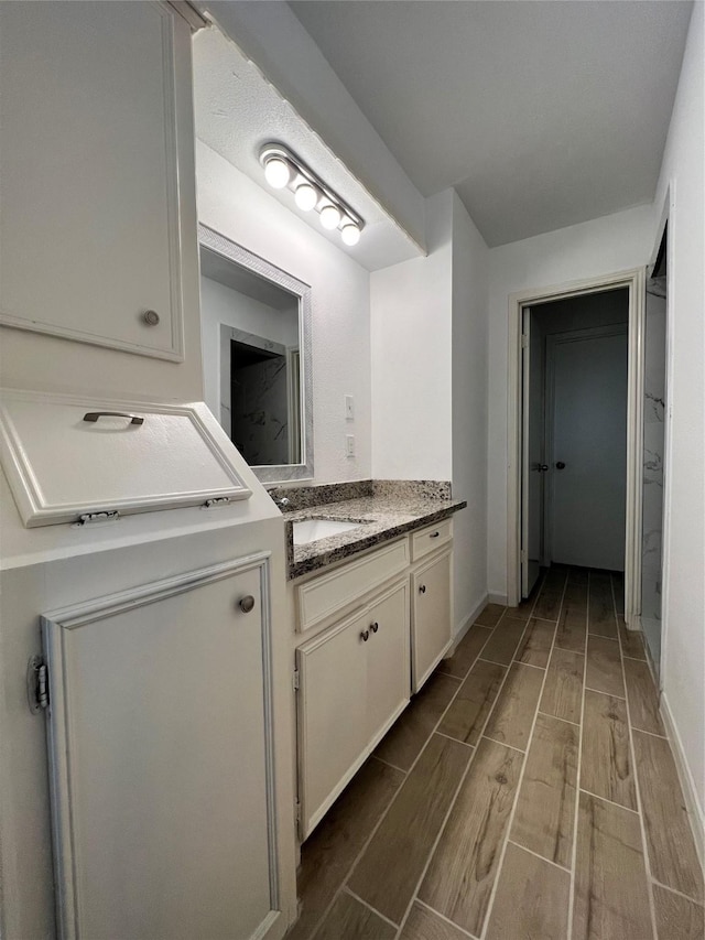 602 Rosewood Dr, Shenandoah, TX 77381 - bathroom featuring wood tiled floors, vanity, and baseboards