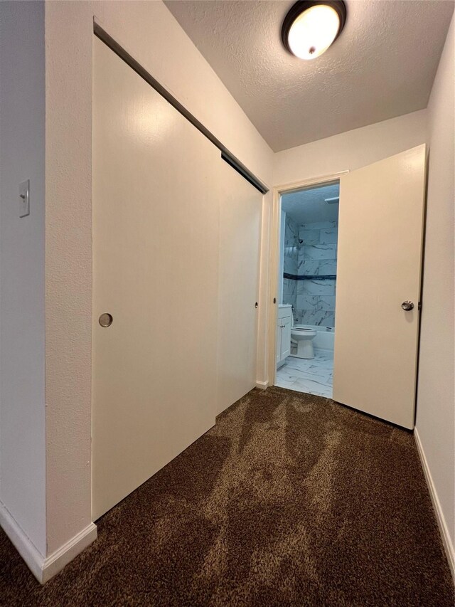 602 Rosewood Dr, Shenandoah, TX 77381 - hallway featuring a textured ceiling, carpet flooring, and baseboards