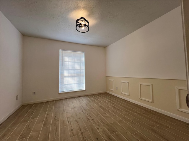 602 Rosewood Dr, Shenandoah, TX 77381 - spare room with dark wood-style flooring, baseboards, and a textured ceiling