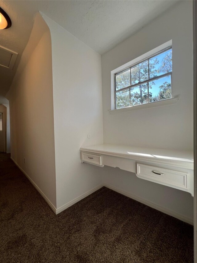 602 Rosewood Dr, Shenandoah, TX 77381 - hallway with dark carpet and baseboards