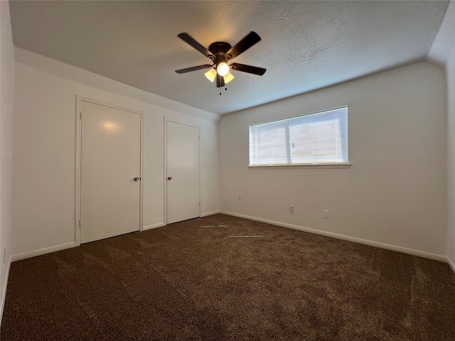 602 Rosewood Dr, Shenandoah, TX 77381 - unfurnished bedroom featuring dark colored carpet, baseboards, and a ceiling fan