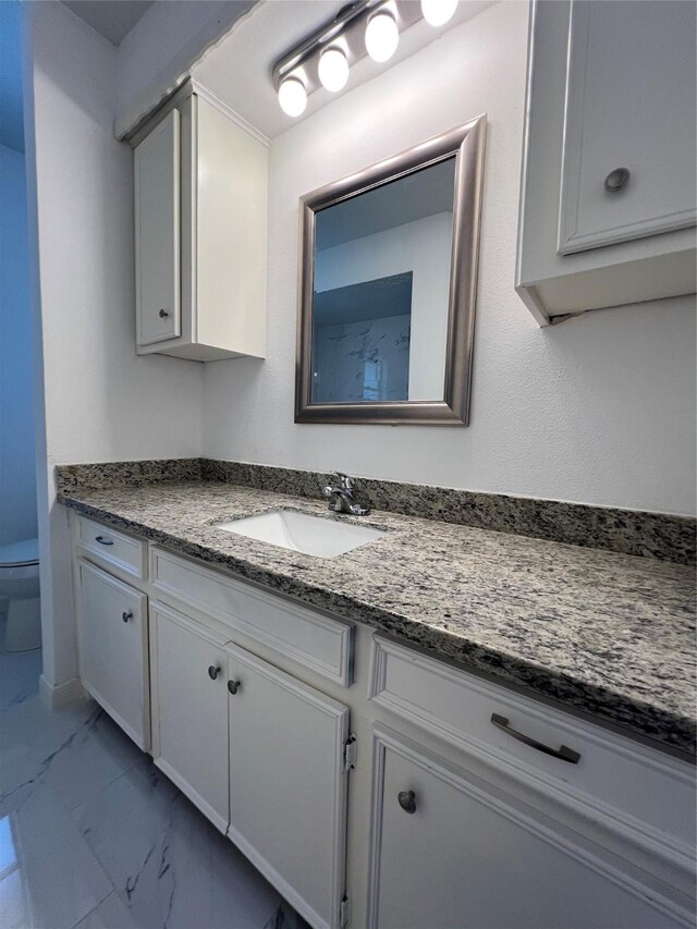 602 Rosewood Dr, Shenandoah, TX 77381 - bathroom featuring marble look tile flooring, toilet, and vanity