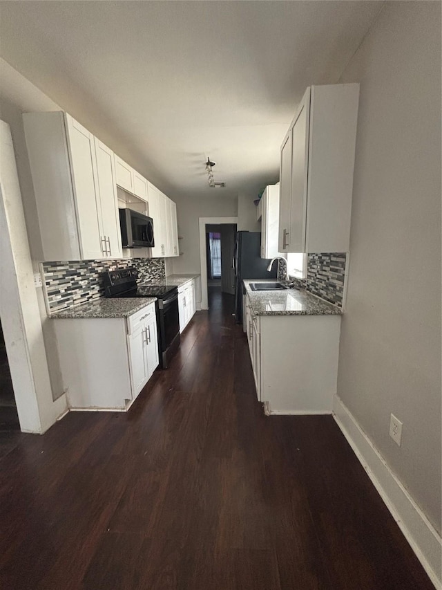 kitchen with black appliances, a sink, tasteful backsplash, and dark wood-style flooring