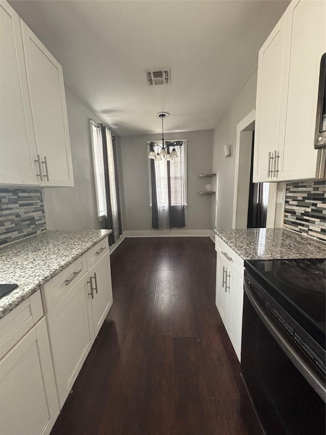 kitchen with black range with electric cooktop, a chandelier, backsplash, and white cabinetry