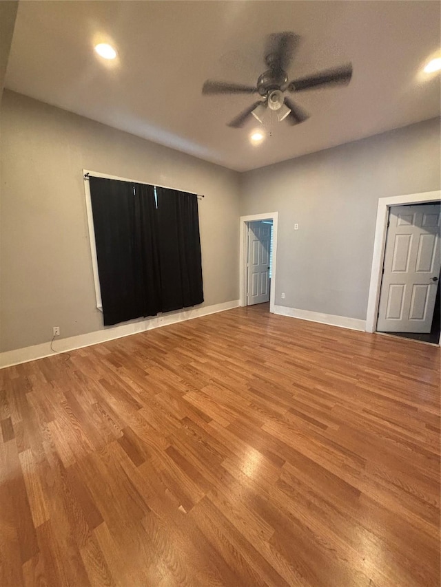 unfurnished bedroom with wood finished floors, baseboards, a ceiling fan, and recessed lighting