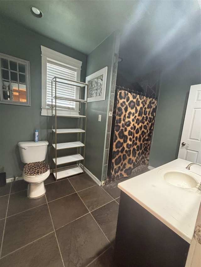 bathroom featuring tile patterned flooring, a sink, toilet, and a shower with shower curtain