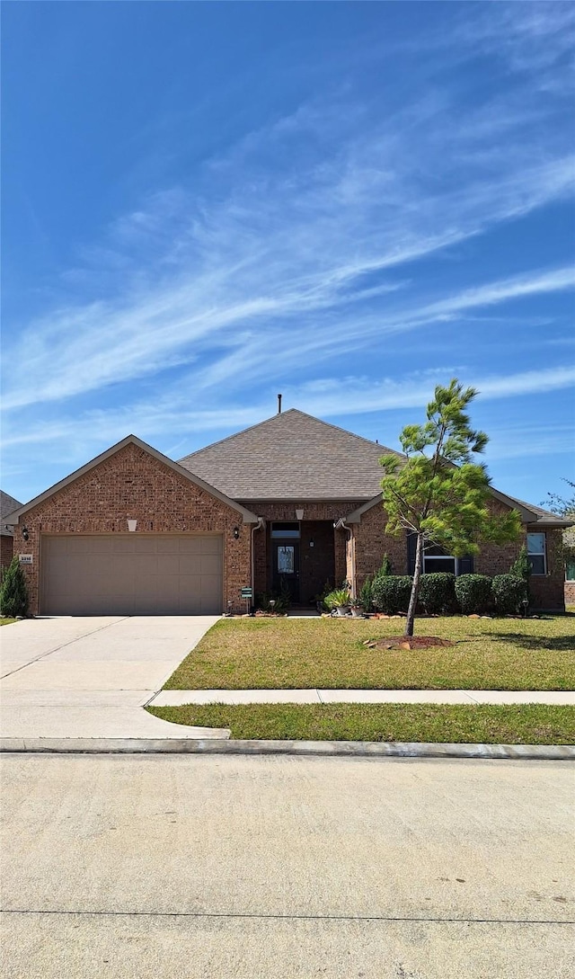 3210 Vintage View Ln, Pearland, TX 77584 - ranch-style house with an attached garage, concrete driveway, a front yard, and brick siding