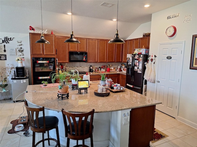 3210 Vintage View Ln, Pearland, TX 77584 - kitchen featuring black appliances, light tile patterned flooring, vaulted ceiling, a breakfast bar, and light stone countertops
