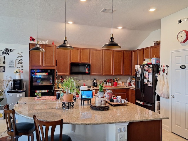3210 Vintage View Ln, Pearland, TX 77584 - kitchen featuring black appliances, light tile patterned flooring, lofted ceiling, a kitchen breakfast bar, and brown cabinetry