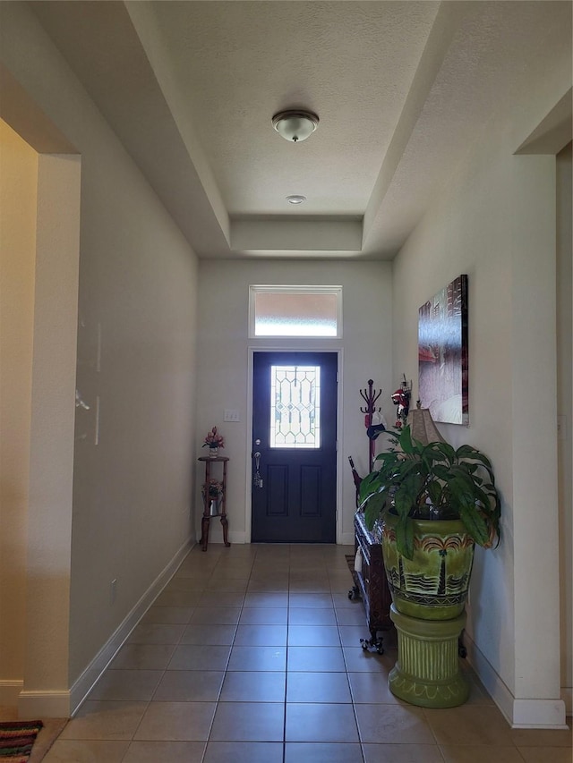 3210 Vintage View Ln, Pearland, TX 77584 - entrance foyer with light tile patterned floors, a raised ceiling, and baseboards