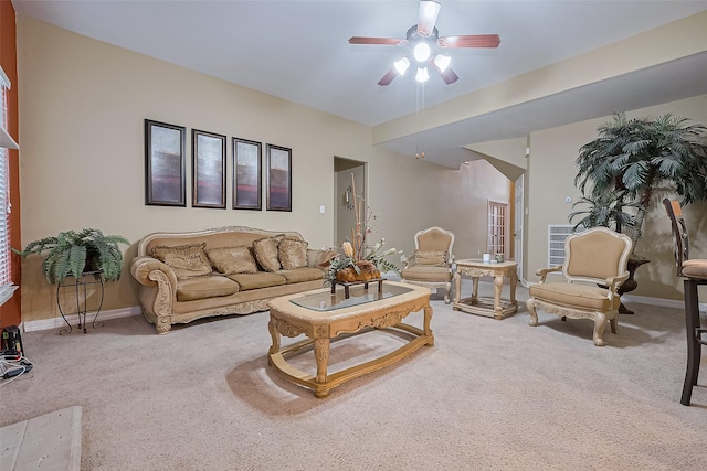 carpeted living area featuring baseboards and a ceiling fan