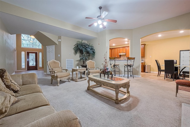 living room with visible vents, arched walkways, a ceiling fan, recessed lighting, and light carpet