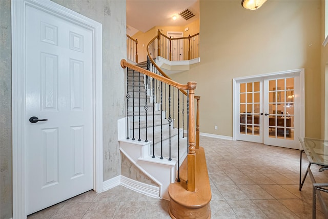 staircase featuring french doors, visible vents, tile patterned floors, and baseboards