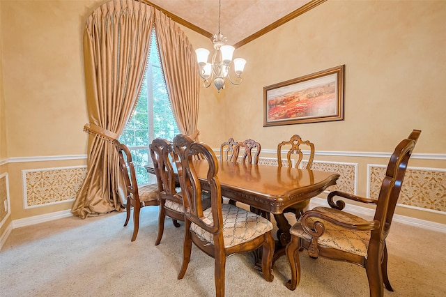 dining room with baseboards, a notable chandelier, ornamental molding, carpet, and wallpapered walls