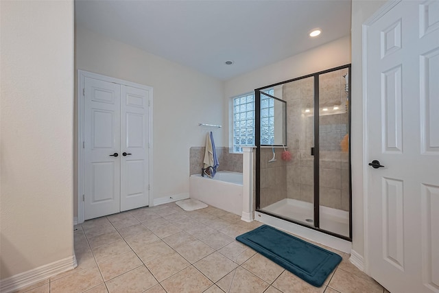 bathroom featuring baseboards, a stall shower, recessed lighting, tile patterned flooring, and a garden tub