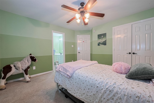carpeted bedroom with a closet, ceiling fan, baseboards, and connected bathroom