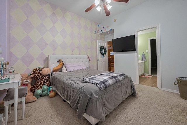 bedroom featuring baseboards, wallpapered walls, connected bathroom, ceiling fan, and light colored carpet
