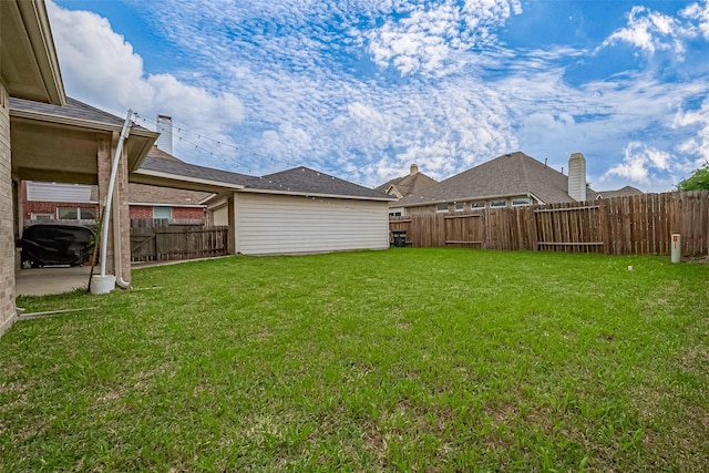view of yard with a fenced backyard