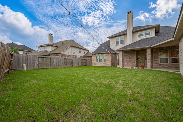 view of yard with a patio area and a fenced backyard