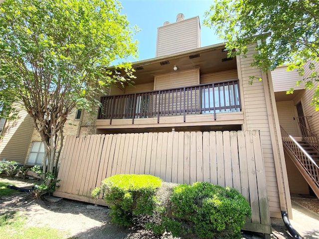 10555 Turtlewood Ct Unit 903, Houston, TX 77072 - rear view of house with stairs and a chimney