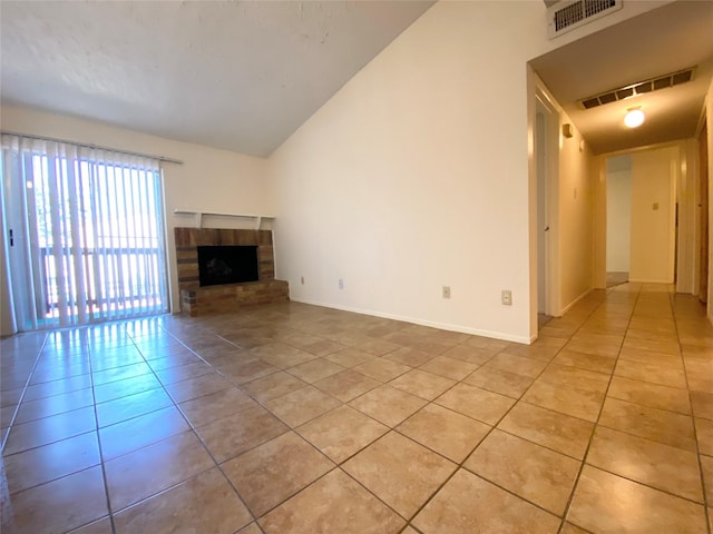 10555 Turtlewood Ct Unit 903, Houston, TX 77072 - unfurnished living room featuring a fireplace with raised hearth, light tile patterned floors, baseboards, and visible vents