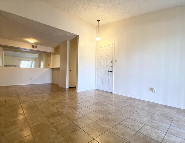 10555 Turtlewood Ct Unit 903, Houston, TX 77072 - empty room featuring light tile patterned floors, visible vents, and a textured ceiling