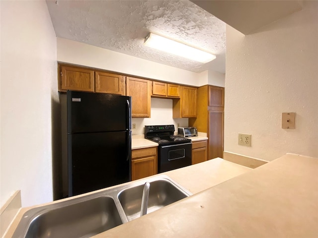 10555 Turtlewood Ct Unit 903, Houston, TX 77072 - kitchen featuring light countertops, a sink, black appliances, and brown cabinetry