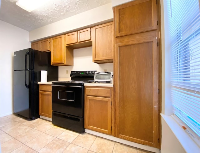 10555 Turtlewood Ct Unit 903, Houston, TX 77072 - kitchen featuring light tile patterned floors, light countertops, and black appliances