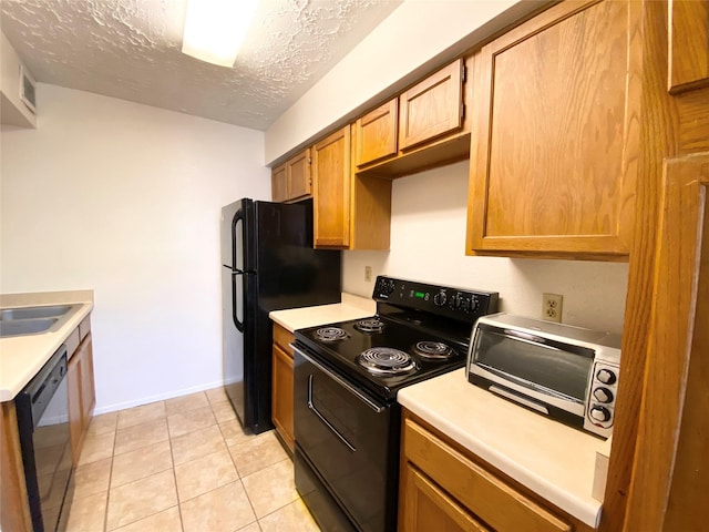 10555 Turtlewood Ct Unit 903, Houston, TX 77072 - kitchen with visible vents, light countertops, black appliances, and a textured ceiling