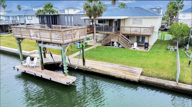 21831 Frio Dr, Galveston, TX 77554 - dock area with stairway, a patio, a deck with water view, and a lawn