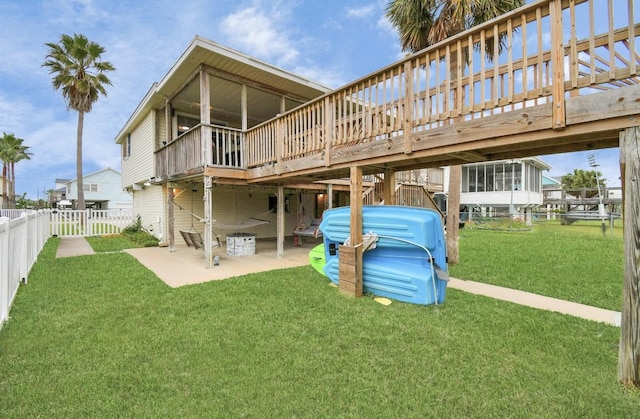 21831 Frio Dr, Galveston, TX 77554 - rear view of property with a yard, a fenced backyard, a deck, and a patio area