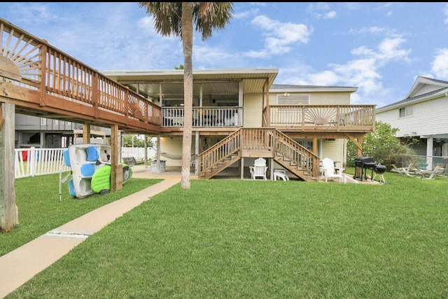 21831 Frio Dr, Galveston, TX 77554 - back of property with stairs, a patio area, a wooden deck, fence, and a lawn