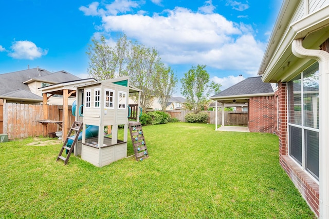24807 Mason Trail Dr, Katy, TX 77493 - view of yard with a patio, a fenced backyard, and a playground
