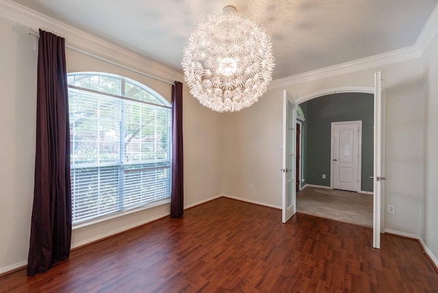 24807 Mason Trail Dr, Katy, TX 77493 - unfurnished dining area with dark wood-type flooring, arched walkways, an inviting chandelier, and ornamental molding
