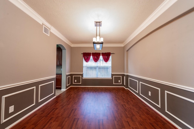 24807 Mason Trail Dr, Katy, TX 77493 - spare room featuring visible vents, arched walkways, crown molding, dark wood-type flooring, and a wainscoted wall