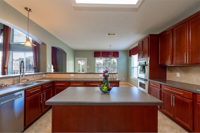24807 Mason Trail Dr, Katy, TX 77493 - kitchen with visible vents, plenty of natural light, a sink, dark countertops, and stainless steel appliances