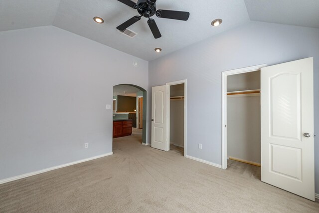 24807 Mason Trail Dr, Katy, TX 77493 - unfurnished bedroom with arched walkways, multiple closets, light colored carpet, and vaulted ceiling
