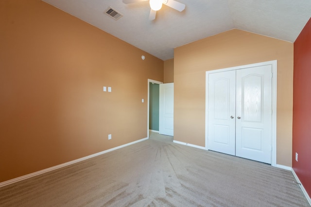 24807 Mason Trail Dr, Katy, TX 77493 - unfurnished bedroom with a closet, baseboards, vaulted ceiling, visible vents, and carpet