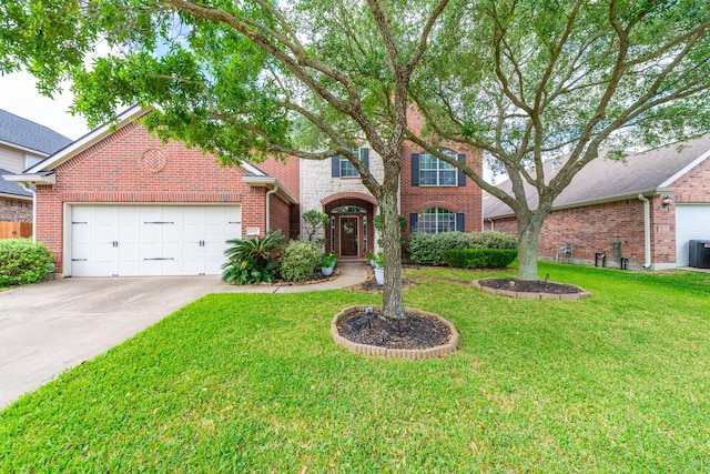 24807 Mason Trail Dr, Katy, TX 77493 - traditional-style house featuring driveway, an attached garage, a front yard, brick siding, and central AC unit