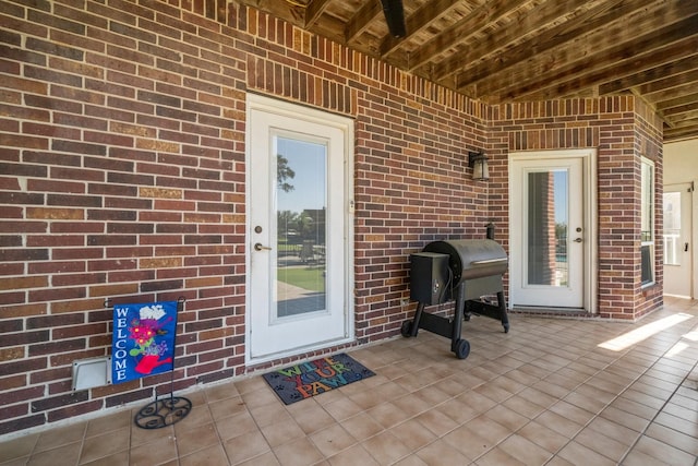2906 Penninsula Pt, Montgomery, TX 77356 - view of exterior entry featuring brick siding and a patio