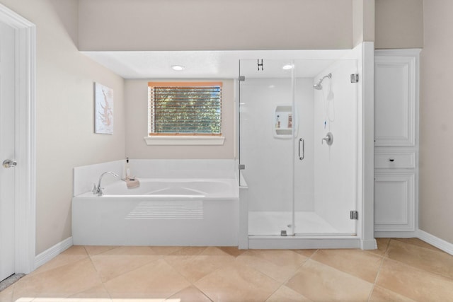 2906 Penninsula Pt, Montgomery, TX 77356 - bathroom with a shower stall, a garden tub, and tile patterned floors