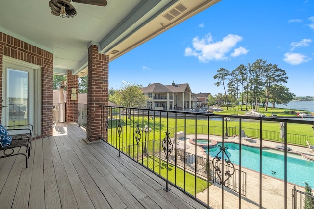 2906 Penninsula Pt, Montgomery, TX 77356 - wooden deck with ceiling fan, a pool with connected hot tub, and a water view