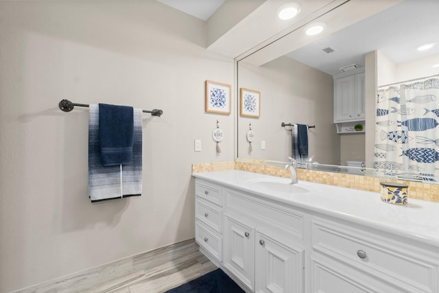 2906 Penninsula Pt, Montgomery, TX 77356 - bathroom with vanity, tasteful backsplash, wood finished floors, and recessed lighting